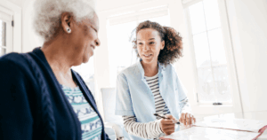 Working for an agency, like this caregiver who’s with a client, can be a choice that leads to a good job.