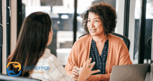 A woman interviews another woman for a caregiver job position.